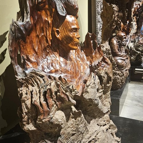 Local artisans carving wood in Ban Nong Bueng