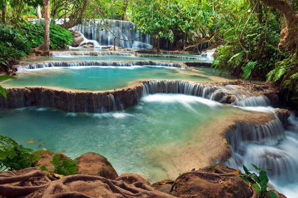 The turquoise tiered pools of Kuang Si waterfalls