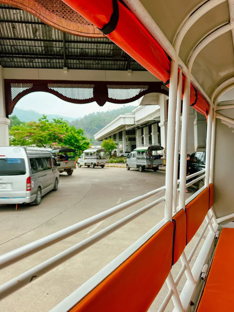 Minivan driving through rural Southern Laos and boarding a wooden ferry boat