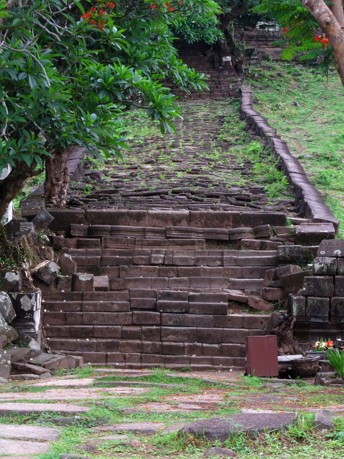 Ancient stone temple ruins of Vat Phu running up the side of a mountain