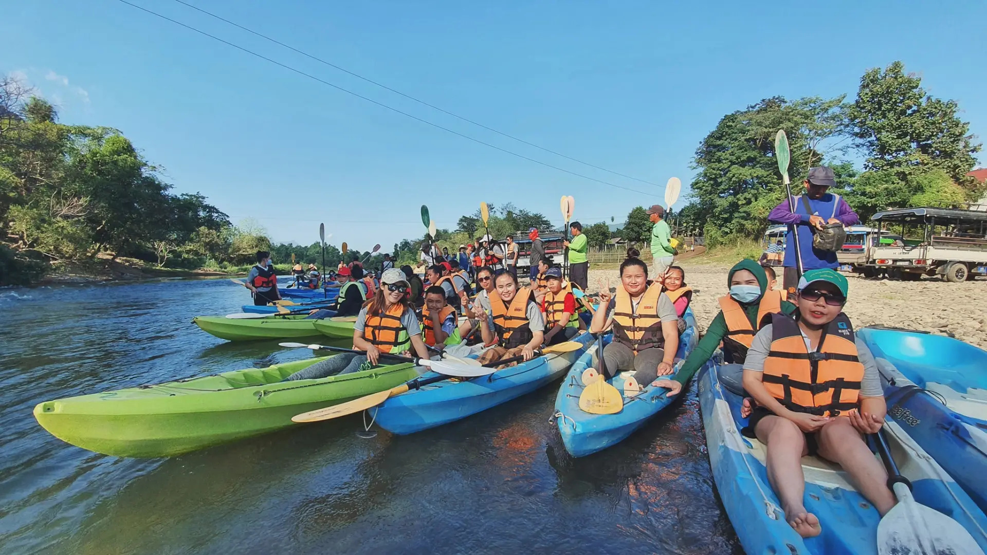 Kayaking safety briefing and paddling instruction on the riverbank