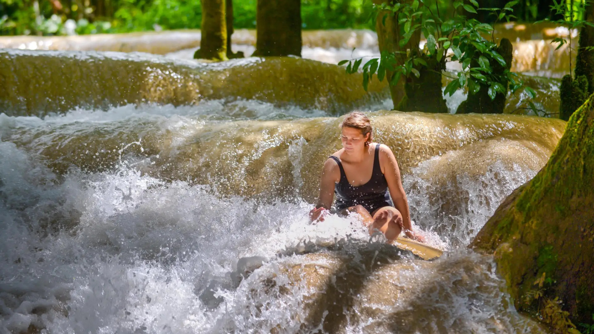 Swimming and jumping off rocks at Tad Etout waterfall