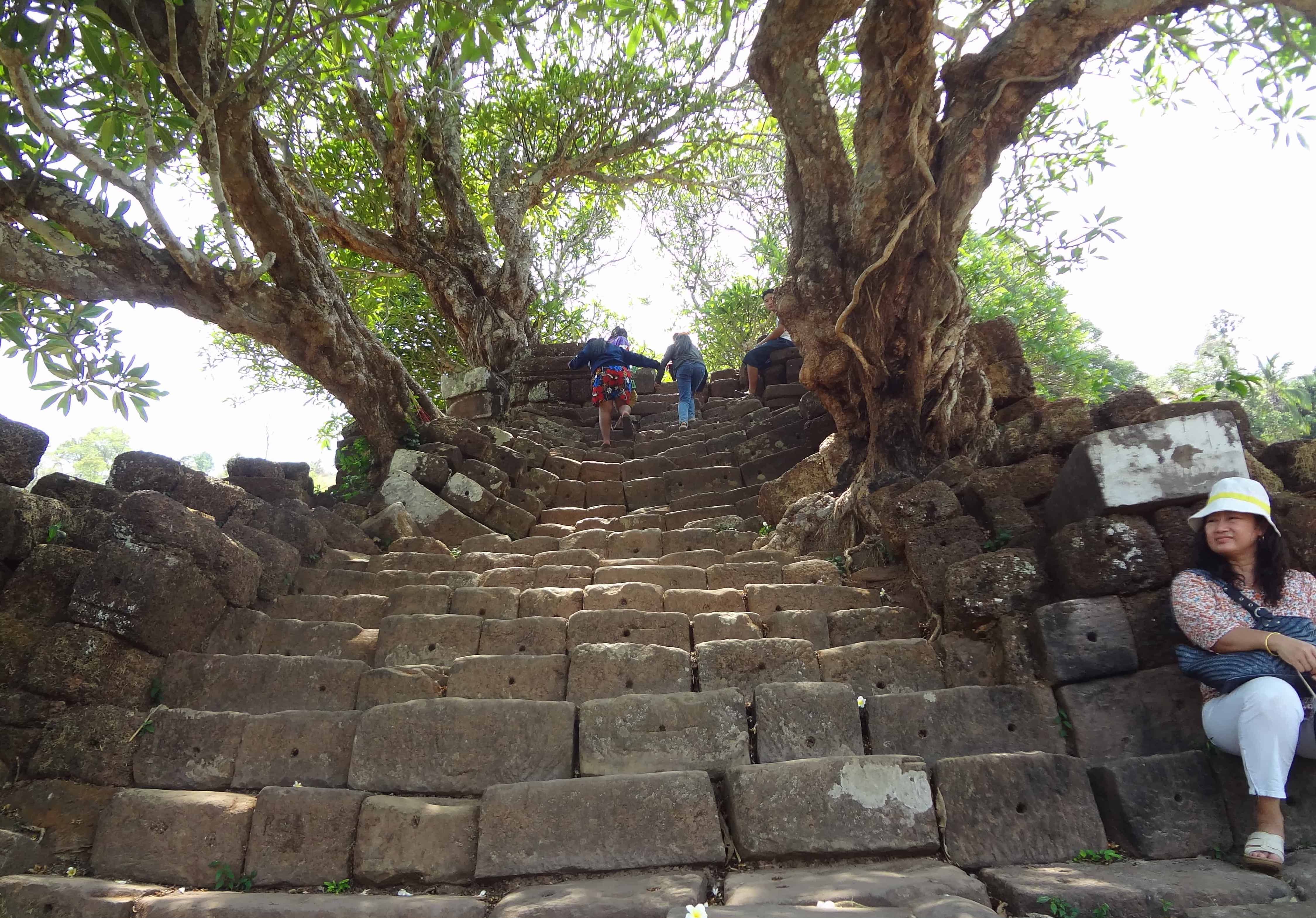 A long concrete stairway leading up a steep hill to Vat Phou Ngoi temple